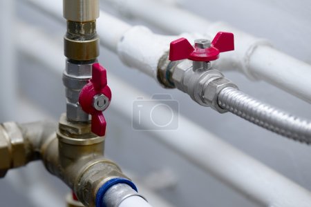 Plumber working on pipes in Battersea SW11